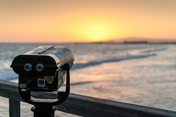istock Coin-operated binoculars on pier overlooking ocean at sunset 166116736
