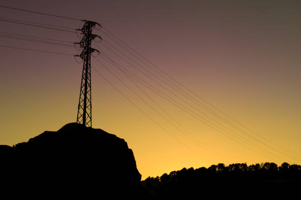 High voltage towers in the mountain at sunset in Spain
