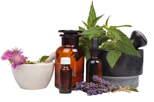 A composition showcasing mortars, fresh herbs, and pharmaceutical bottles, emphasizing the concept of alternative medicine.