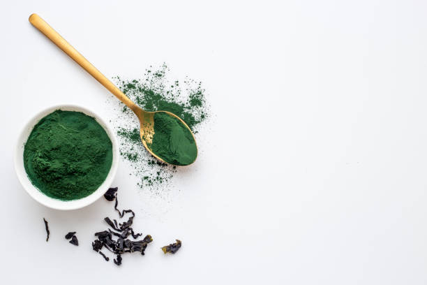 Super food - Spirulina Chlorella algae with powder, top view Super food - Spirulina Chlorella algae with powder, top view. chlorella stock pictures, royalty-free photos & images