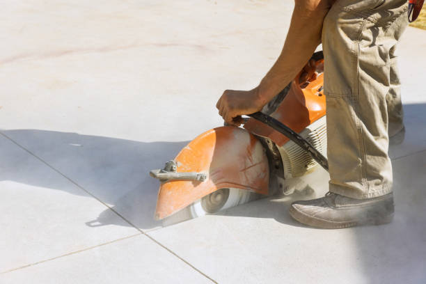 istock Contractor Utilizes Diamond Blade Saw to Cut Concrete Paving Sidewalk 1661195248