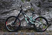 mountain bike for downhill and other types of skiing in the mountains and mountainous areas. mtb and downhill bike no people standing leaning on a stone