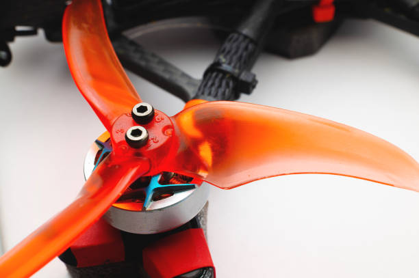 Drone arm with mounted brushless motor and 3-blade propeller. The concept of fpv and drone building stock photo