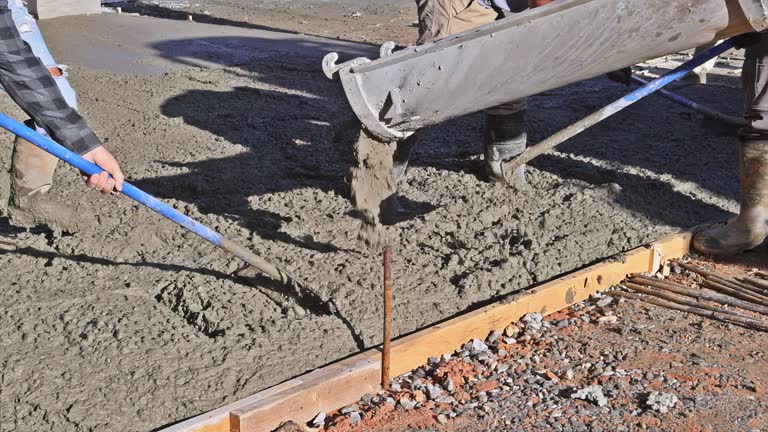 Freshly mixed concrete poured by truck for new house paving