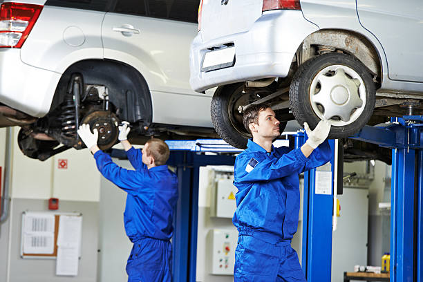 istock Auto mechanics working on car suspension 166122173