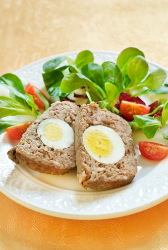 Easter baked meatloaf with boiled eggs and salad