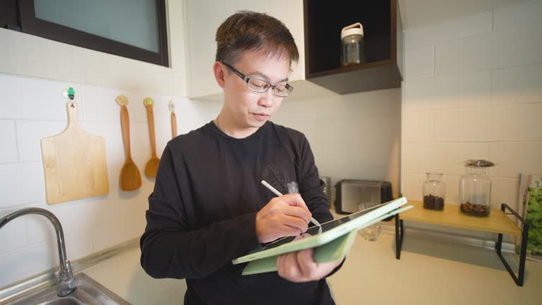 Work From Home, Man Working With Tablet In A Home Kitchen