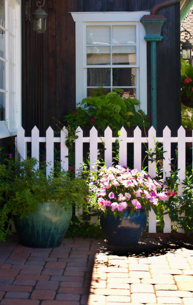 istock Wood shingle cottage with white picket fence 1661238433