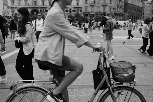 Milano, Italy - September 05, 2023: people across Piazza del Duomo walking and with bike