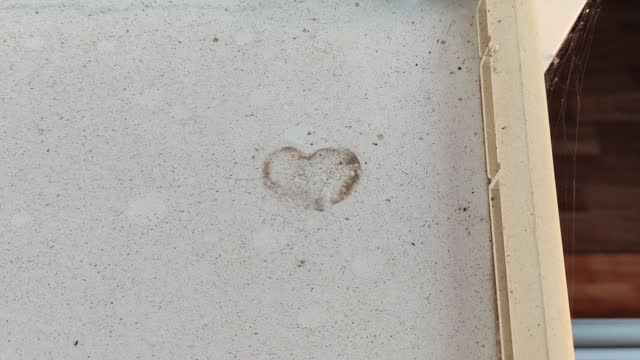 Printing on the surface of sand or dust in the shape of a heart