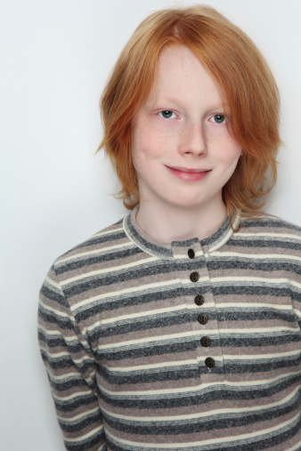 Portrait of handsome redhead freckled smiling teen boy