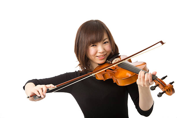 istock Asian Woman Smiling While Playing the Violin 166125681