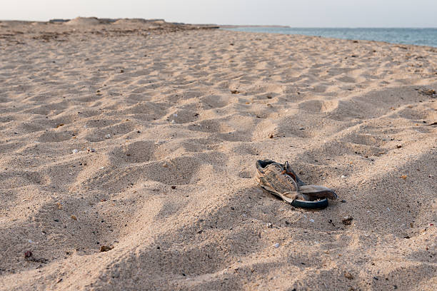 istock Old worn out shoe in the sands 166125806