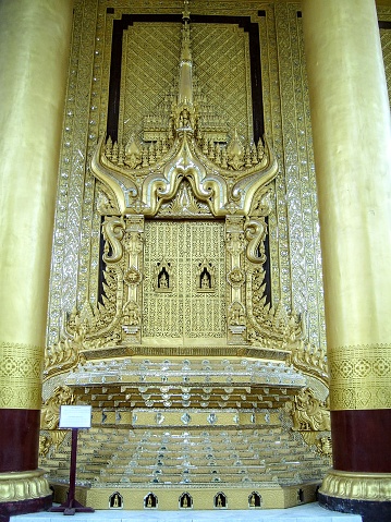 Bago. The original palace was built for King Bayinnaung but burnt down in 1599. It was reconstructed about 20 years ago. It is rebuilt following the original design. It is a very ornate golden palace. This picture shows a replica of one of the original thrones, called The Lion Throne. Between the 2 pillars you get a good view on this beautiful golden throne.