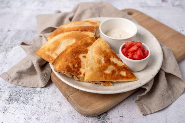istock Golden and crispy chicken and cheese quesadilla with sides 1661264645