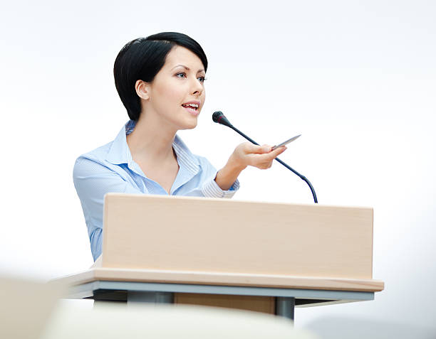 istock Pretty woman speaker at the podium 166127053