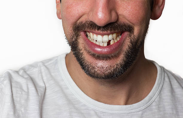 Man Missing Tooth Close up on a man smiling while he is missing a tooth. gap toothed photos stock pictures, royalty-free photos & images