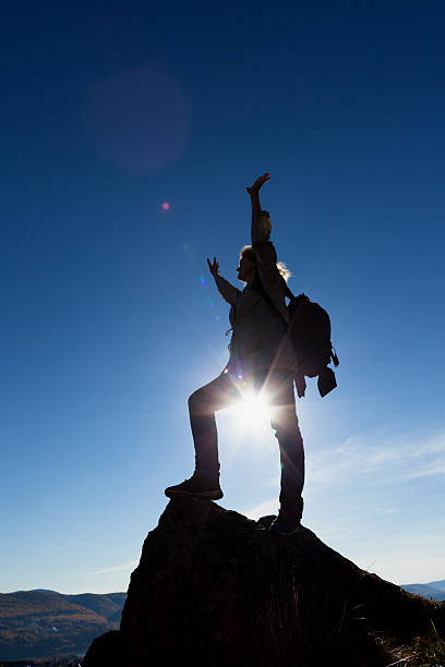 istock woman silhouette and  mountain sunset 166128960