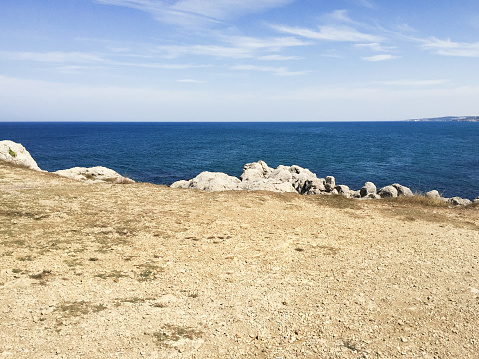 Coastline rocks, sea and sky background with copy space