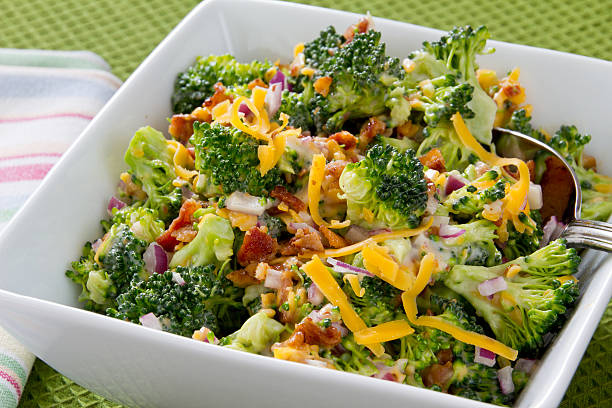Broccoli Salad with Cheese and Bacon Broccoli salad with cheddar cheese, bacon, and red onion combined with a mayonnaise dressing broccoli stock pictures, royalty-free photos & images