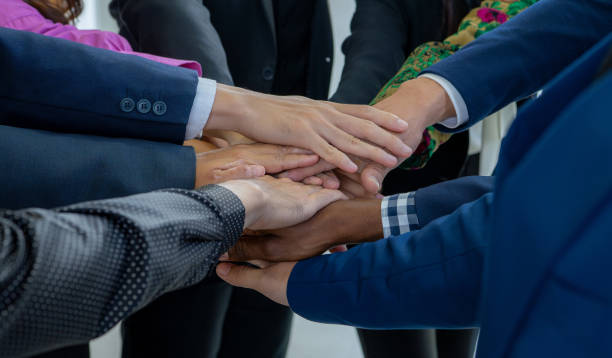 istock Team, teamwork, and unity concept. Diverse team putting hands together. Group of diverse business people. Working together as a team. Partnership and togetherness create a strong sense of community. 1661321345