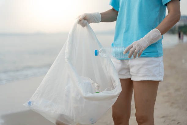 istock Save water. Volunteer pick up trash garbage at the beach and plastic bottles are difficult decompose prevent harm aquatic life. Earth, Environment, Greening planet, reduce global warming, Save world 1661337933