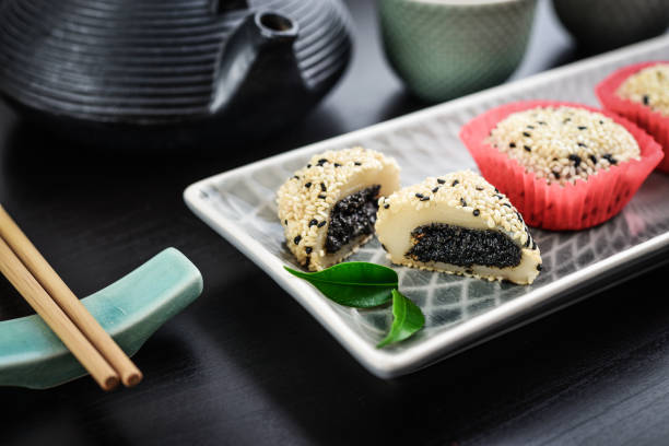 istock Mochi assortment on plate with chopticks and green tea 1661347771