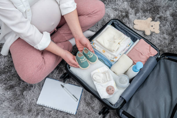 istock Pregnant woman's top view, floor-based preparations, packing with precision her maternity essentials, encapsulating the future mother's emotions 1661359717