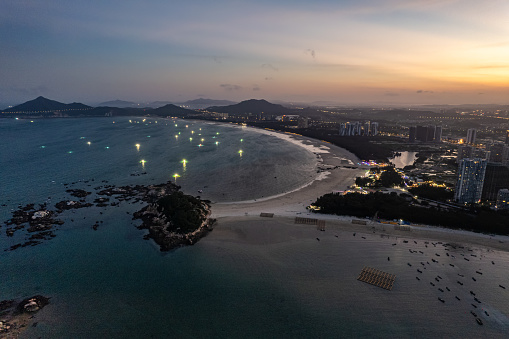 Aerial view of the seaside town and fishing boats at dusk