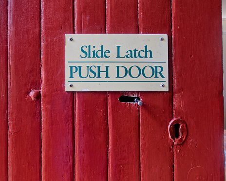 Slide latch, push door, sign for idiots on a door