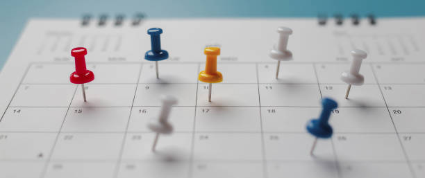 istock Embroidered red pins on a calendar event Planner calendar,clock to set timetable organize schedule,planning for business meeting or travel planning concept. 1661368161