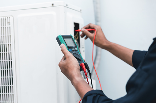 Air conditioner technicians use a multimeter to check electricity and Part of the preparation to install a new air conditioner.