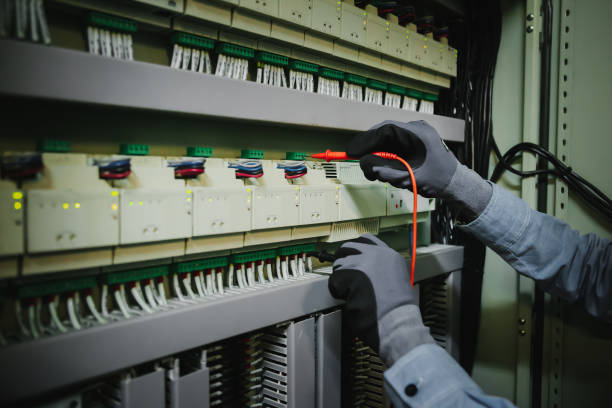 istock Electrical engineers test electrical installations and wiring on protective relays, measuring them with a multimeter. 1661369311