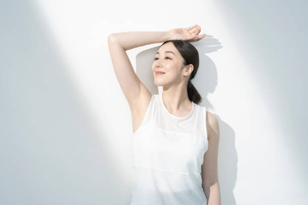 Asian woman with one arm up.