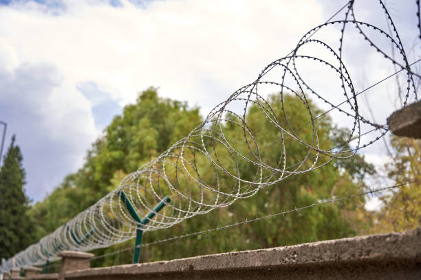 istock Barbed wire over the fence 1661392435