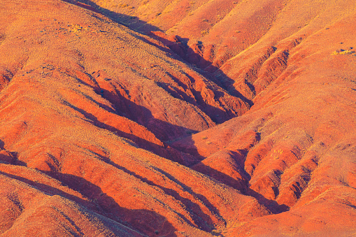 Red colorful mountains in canyon at sunset. Kyzyl-Chin valley in Altai, Siberia, Russia. Abstract nature background