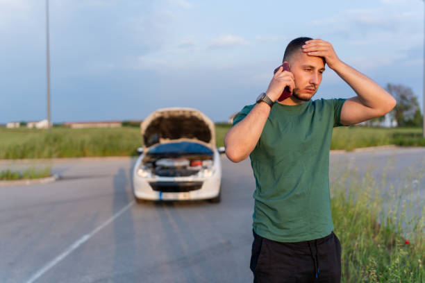 istock The young man's car has broken down, and he's on the phone, seeking immediate help 1661397774