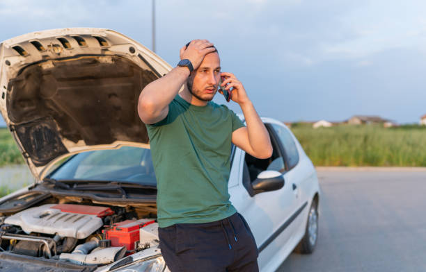 istock A young man's car has broken down on the roadside, and he's resorting to his mobile phone to call for towing assistance 1661398895