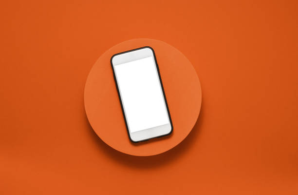 istock Smartphone with white empty screen on the orange podium at the orange background 1661398915