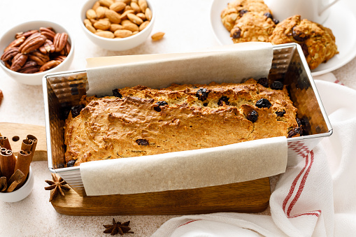 Fruitcake with cranberry, almond and pecan nuts in baking form