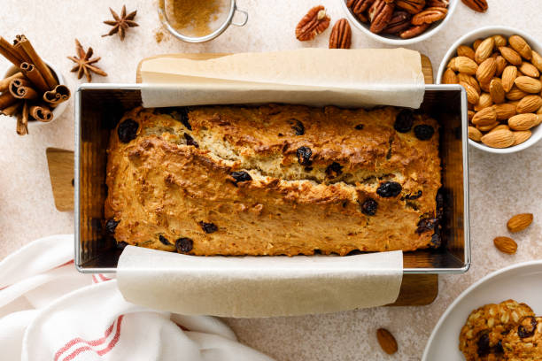istock Fruitcake with cranberry, almond and pecan nuts in baking form 1661404655