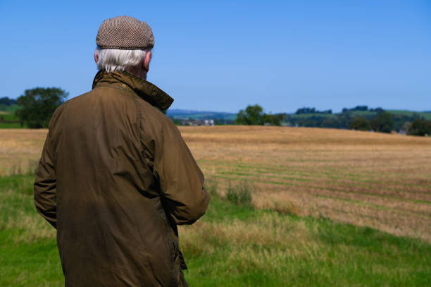 istock Mature man looking at a recently harvested field 1661412717