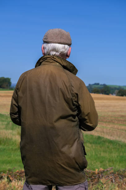 istock Farmer looking at a recently harvested field 1661413264