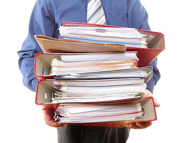 istock Male office worker carrying a stack of files 166141753