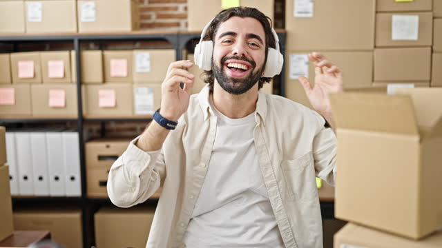 Young hispanic man ecommerce business agent on a video call showing package at office