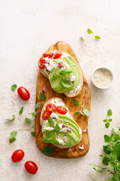 istock Avocado toast with cheese cottage, tomato and herbs for breakfast 1661422169