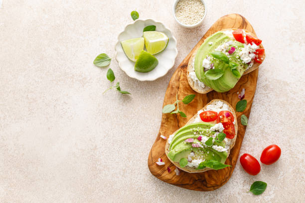 istock Avocado toast with cheese cottage, tomato and herbs for breakfast 1661422170