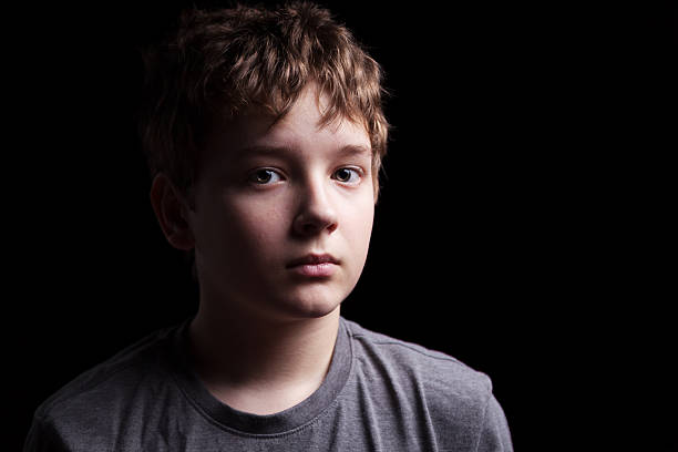 Portrait of the boy on black stock photo