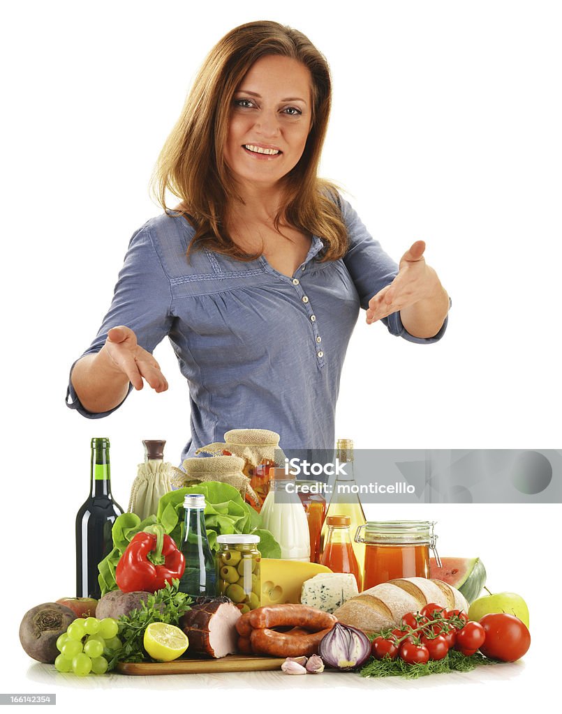 Young woman with variety of grocery products Young woman with variety of grocery products. Adult Stock Photo
