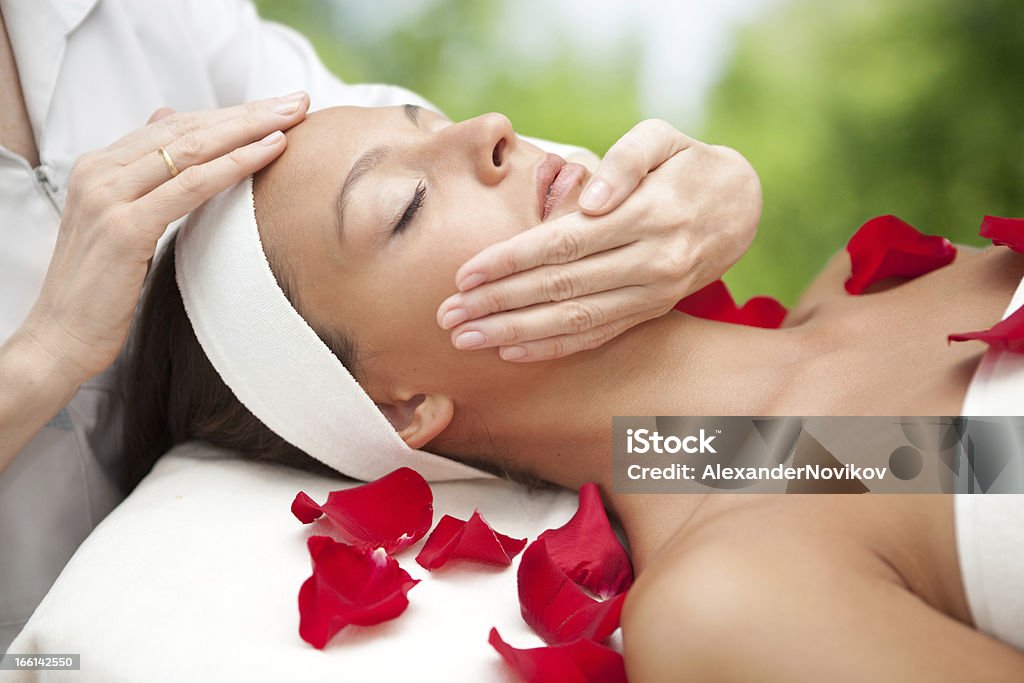 Spa salon: Young Beautiful Woman Having Facial Massage. Young Beautiful Relaxing  Woman  Having a Facial Massage. Facial Massage Stock Photo